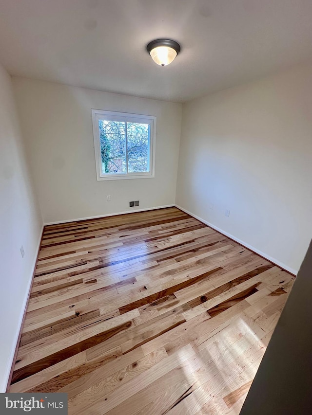 spare room featuring light hardwood / wood-style floors