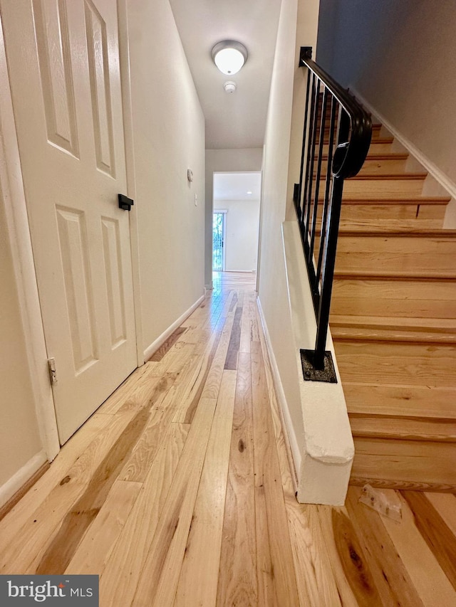 corridor with hardwood / wood-style floors