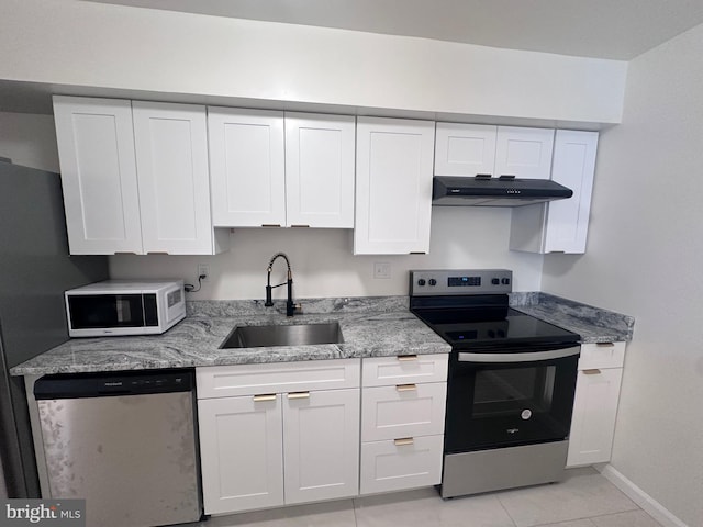 kitchen featuring sink, light tile patterned floors, white cabinets, and appliances with stainless steel finishes