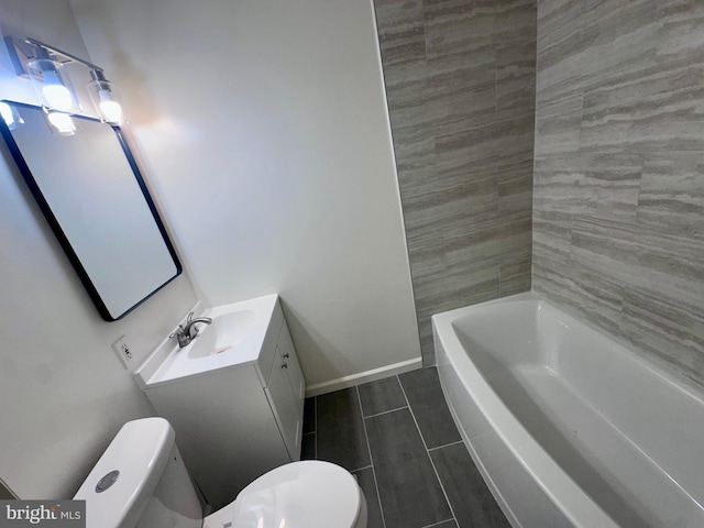 bathroom with vanity, a bathtub, and toilet