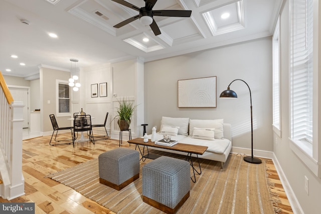 sitting room with light wood-type flooring, ornamental molding, coffered ceiling, ceiling fan, and beam ceiling