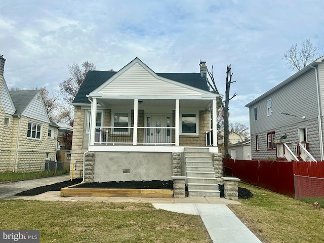 view of front of home with covered porch and a front yard