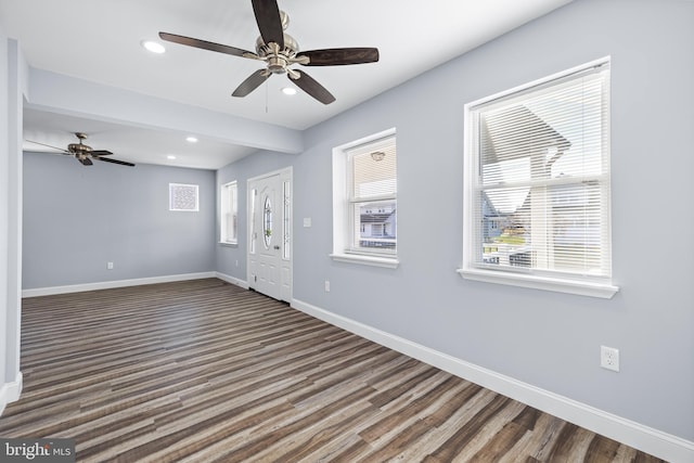 foyer entrance featuring ceiling fan and dark wood-type flooring