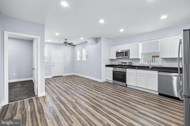 kitchen featuring white cabinetry, sink, ceiling fan, hardwood / wood-style floors, and appliances with stainless steel finishes