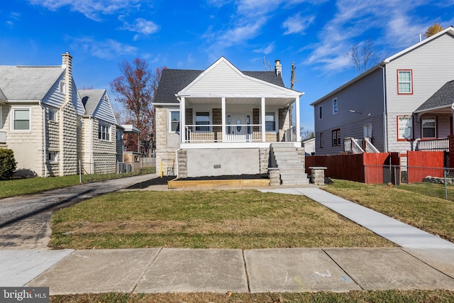 bungalow featuring a porch and a front lawn