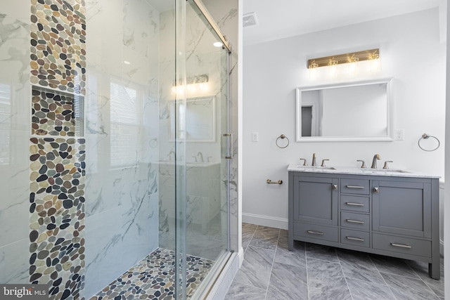 bathroom with vanity and a shower with door