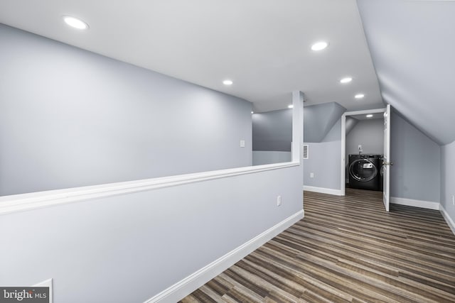 additional living space featuring washer / clothes dryer, dark hardwood / wood-style flooring, and lofted ceiling