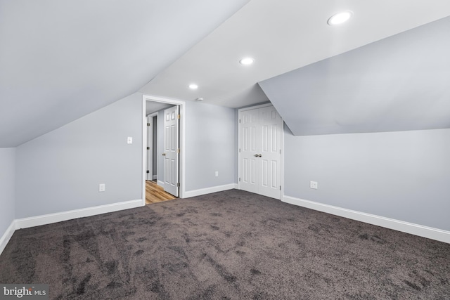 bonus room featuring carpet floors and vaulted ceiling