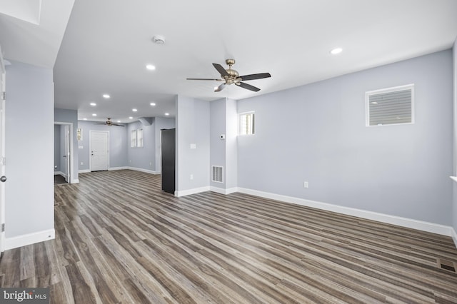 unfurnished living room with dark hardwood / wood-style floors and ceiling fan