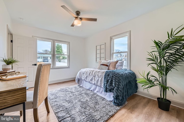 bedroom with hardwood / wood-style floors and ceiling fan