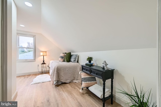 bedroom featuring wood-type flooring and vaulted ceiling