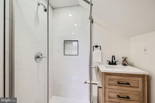 bathroom with vanity and a shower with door