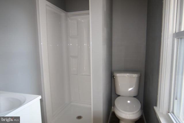 bathroom with toilet and walk in shower