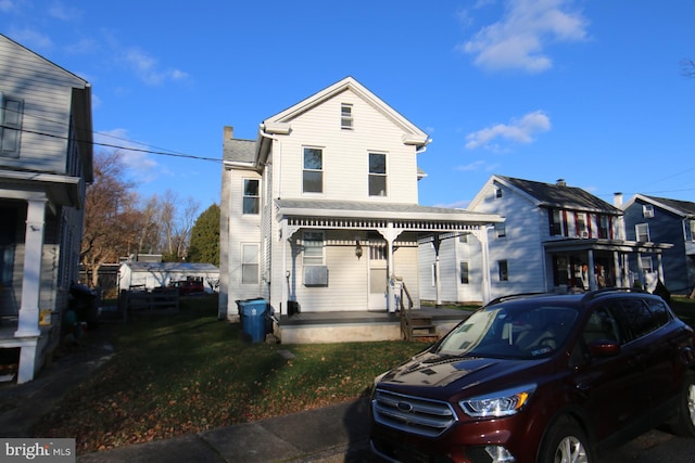 front of property featuring covered porch and a front yard