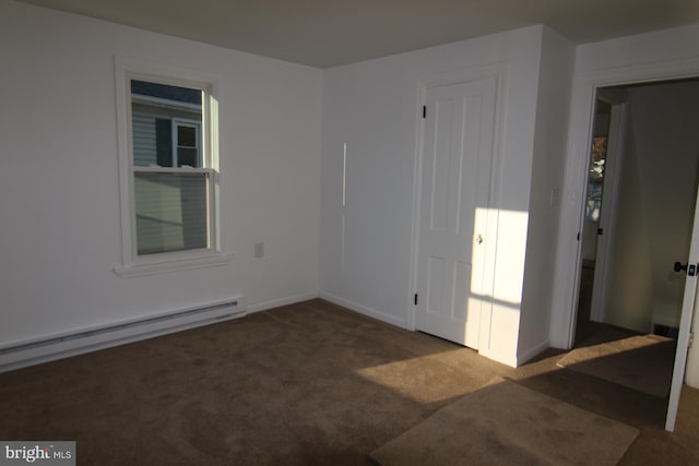 carpeted spare room featuring a baseboard radiator