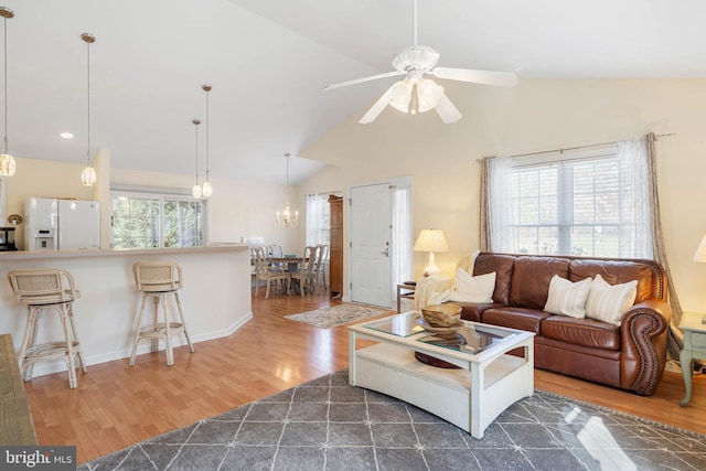 living room featuring ceiling fan, dark hardwood / wood-style flooring, lofted ceiling, and a wealth of natural light