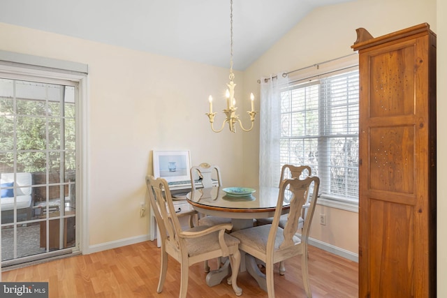 dining area featuring light hardwood / wood-style floors, vaulted ceiling, and a notable chandelier