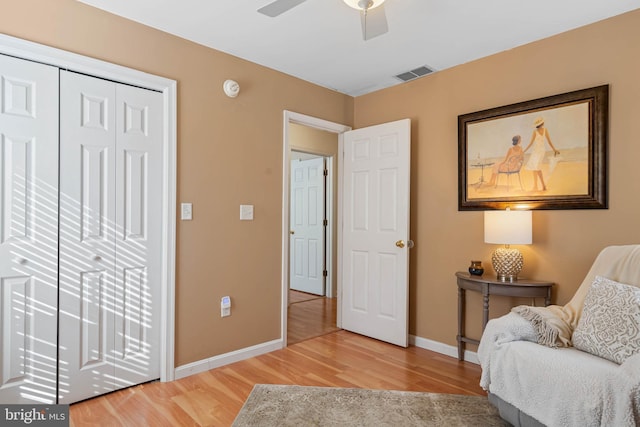 sitting room featuring ceiling fan and wood-type flooring