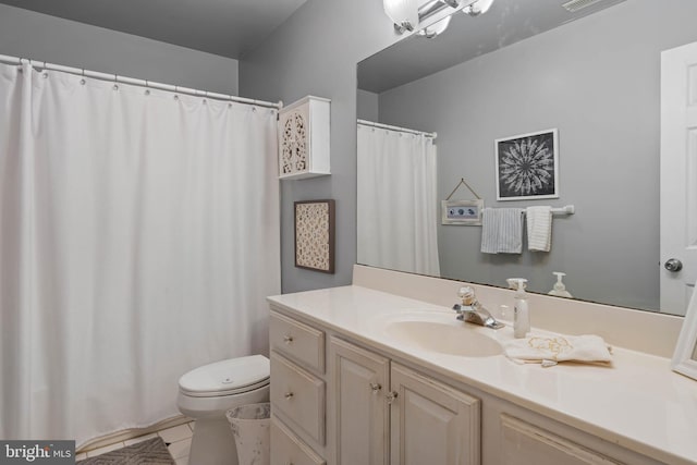 bathroom featuring toilet, vanity, and tile patterned floors