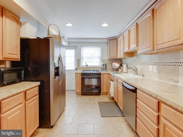 kitchen featuring light brown cabinets, light tile patterned flooring, sink, and appliances with stainless steel finishes