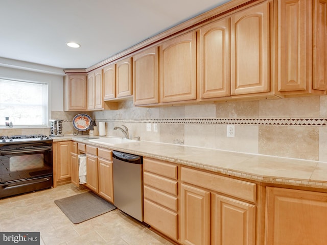 kitchen with tasteful backsplash, stainless steel dishwasher, sink, light brown cabinets, and black range