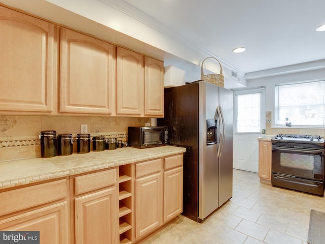 kitchen featuring light brown cabinets, black appliances, crown molding, light tile patterned floors, and tasteful backsplash