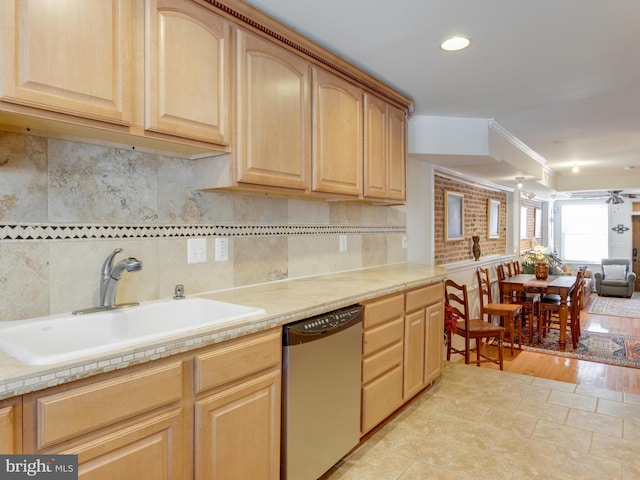 kitchen featuring dishwasher, sink, light brown cabinetry, and light hardwood / wood-style flooring