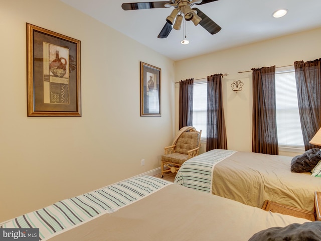 bedroom featuring ceiling fan and multiple windows