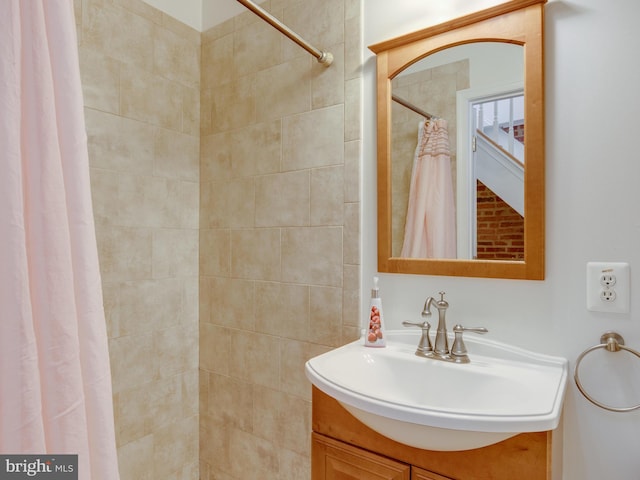 bathroom featuring vanity and curtained shower