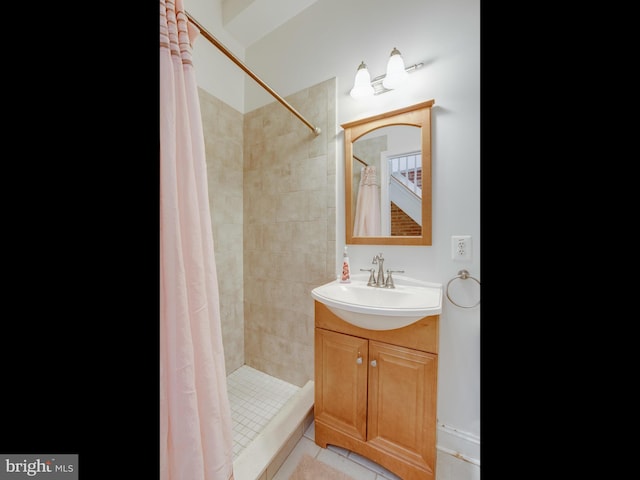 bathroom featuring tile patterned flooring, a shower with curtain, and vanity