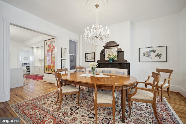 dining room featuring light hardwood / wood-style floors and an inviting chandelier