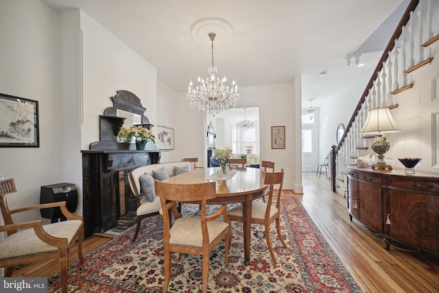 dining space with a chandelier and light wood-type flooring