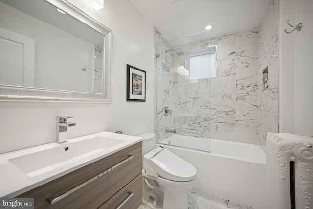 full bathroom featuring vanity, tiled shower / bath combo, and toilet