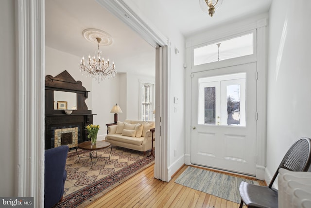 foyer featuring light hardwood / wood-style flooring and an inviting chandelier