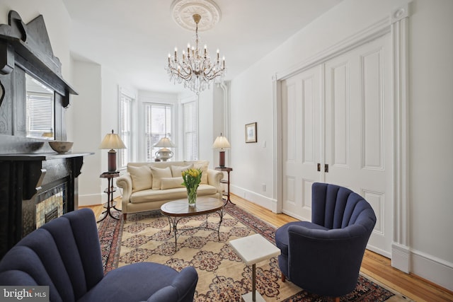 living room with a notable chandelier and light hardwood / wood-style floors