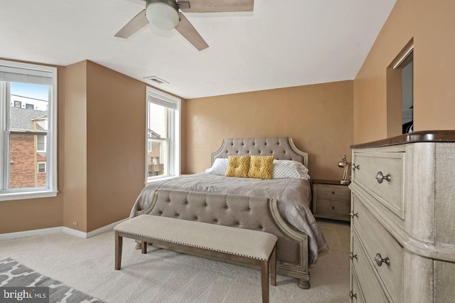 carpeted bedroom featuring ceiling fan and multiple windows