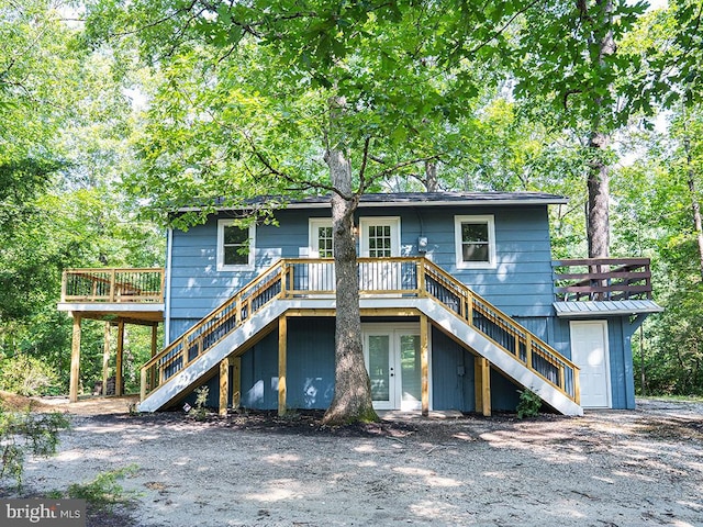 rear view of property with french doors and a deck