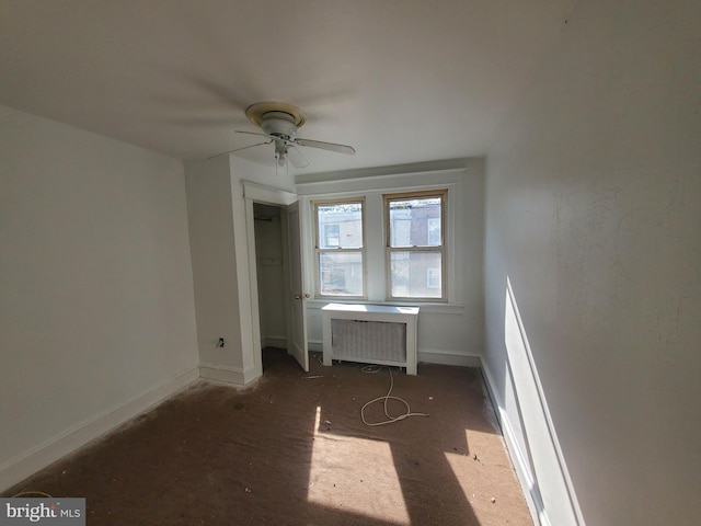 unfurnished bedroom with radiator heating unit and ceiling fan