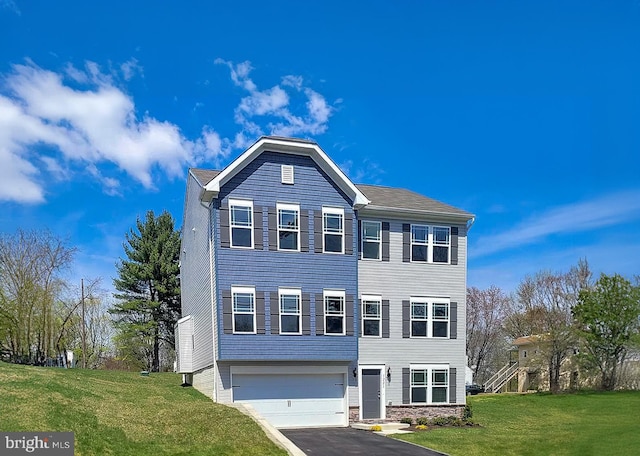 view of front facade featuring a front lawn and a garage