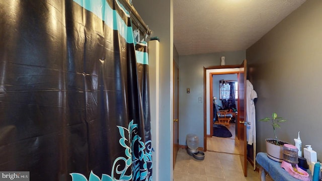 hallway with a textured ceiling