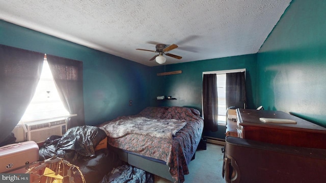 carpeted bedroom featuring a textured ceiling, ceiling fan, and cooling unit