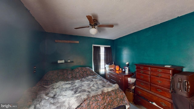 bedroom with a textured ceiling and ceiling fan