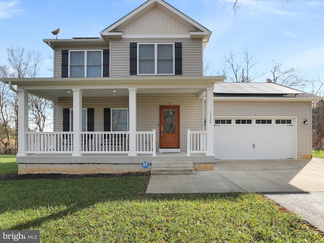 view of front of home with a front yard, covered porch, a garage, and solar panels