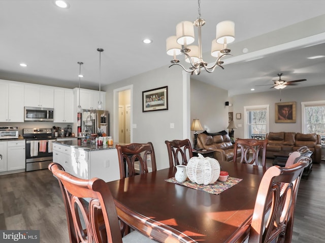 dining room featuring ceiling fan with notable chandelier and dark wood-type flooring