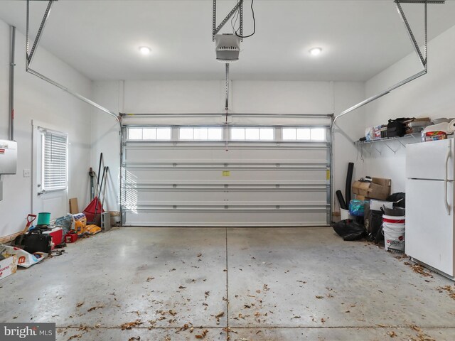 1150 Lewisville Rd, Berryville, VA 22611 - garage featuring freestanding refrigerator and a garage door opener