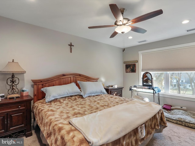 bedroom with ceiling fan and light colored carpet