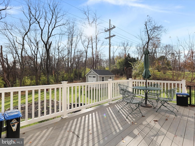 deck featuring grilling area and an outbuilding