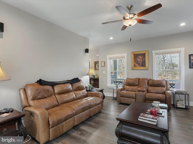 living room featuring dark hardwood / wood-style floors, ceiling fan, and plenty of natural light