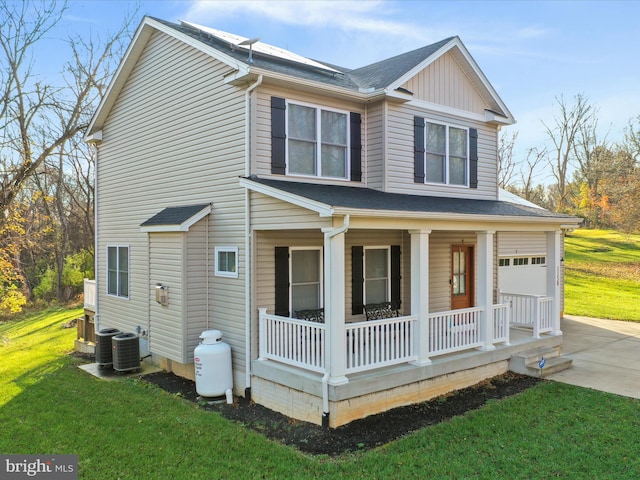 view of front of house featuring a porch, central air condition unit, and a front lawn