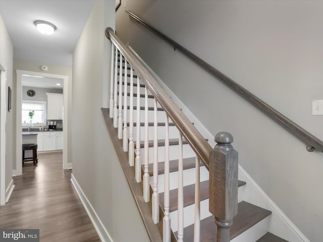 stairs featuring wood-type flooring